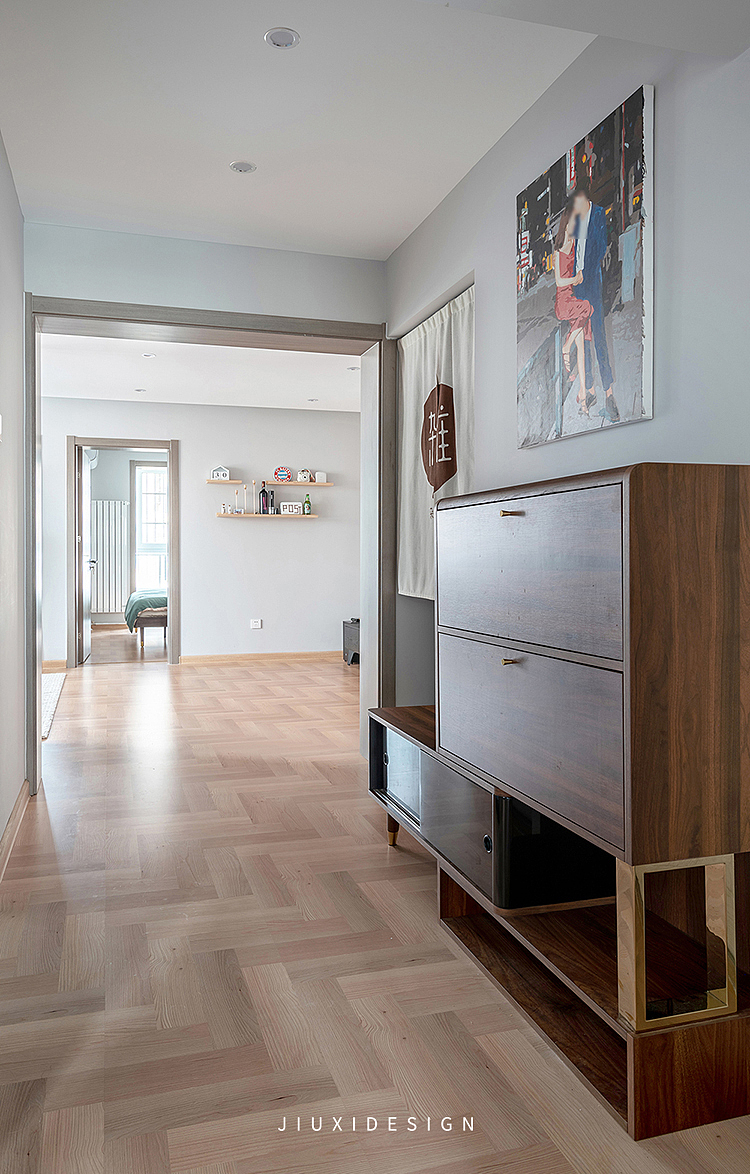 从门厅区域往客厅方向看,地面整体通铺木地板,在视觉感上扩大空间感.