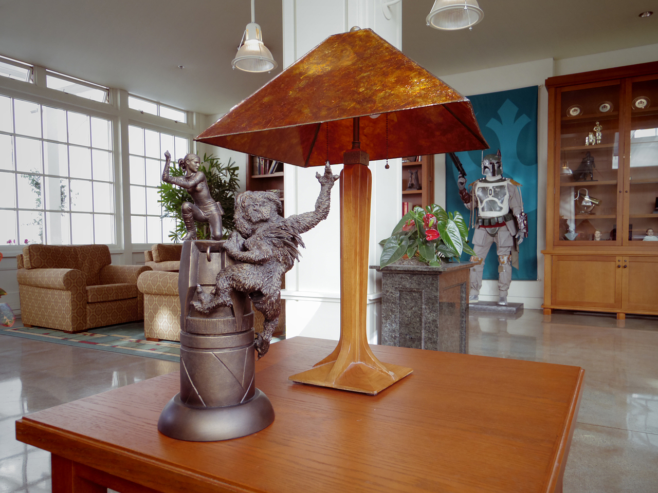 茶几上的复古台灯与铜质小雕像。