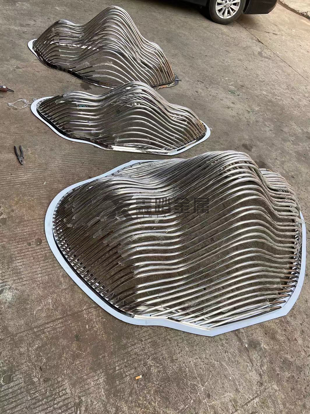 镜面不锈钢圆管假山雕塑在售楼部有着多方面的造景功能