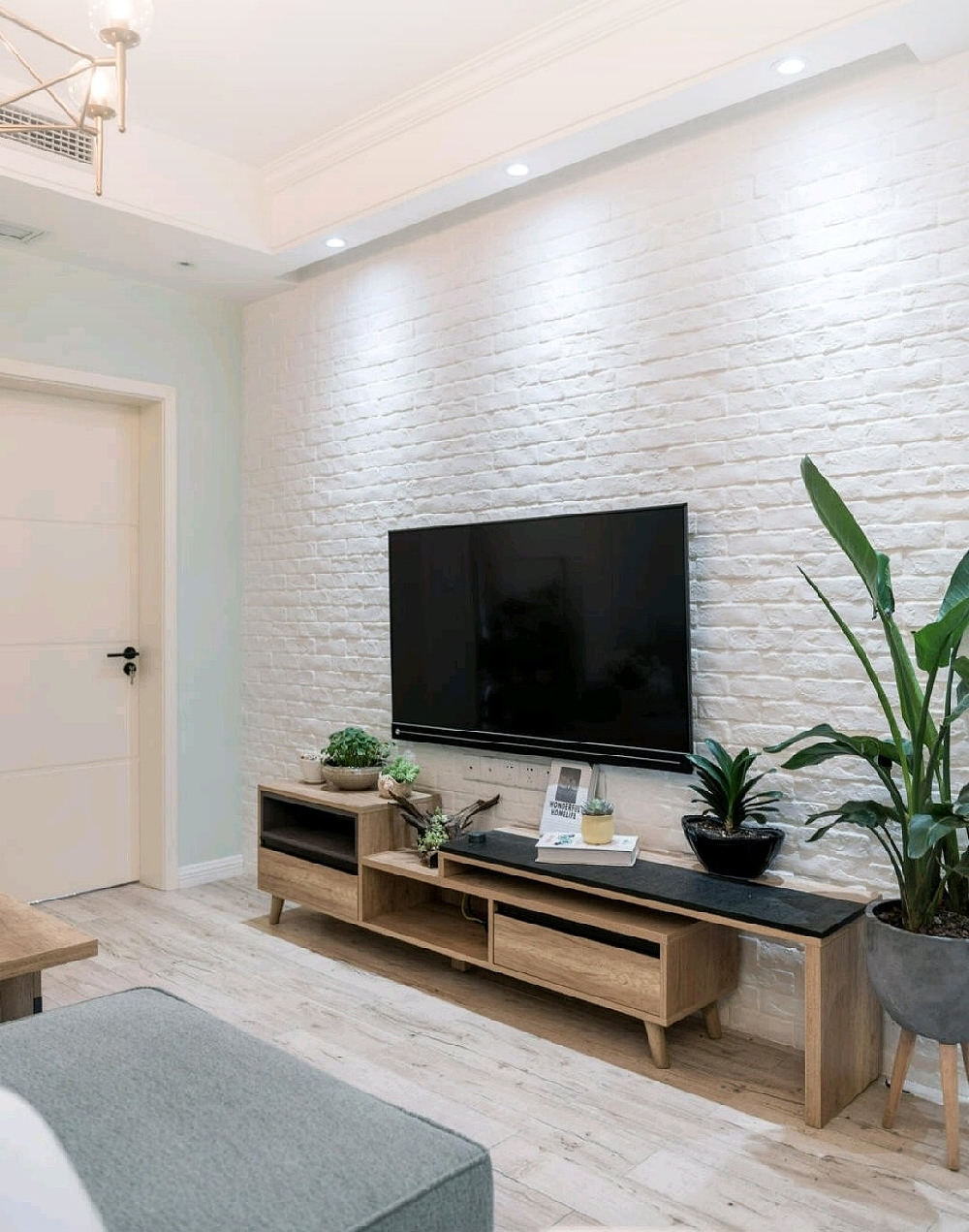 白色文化砖,配色木色的电视柜,让单一的墙面显得更有质感。