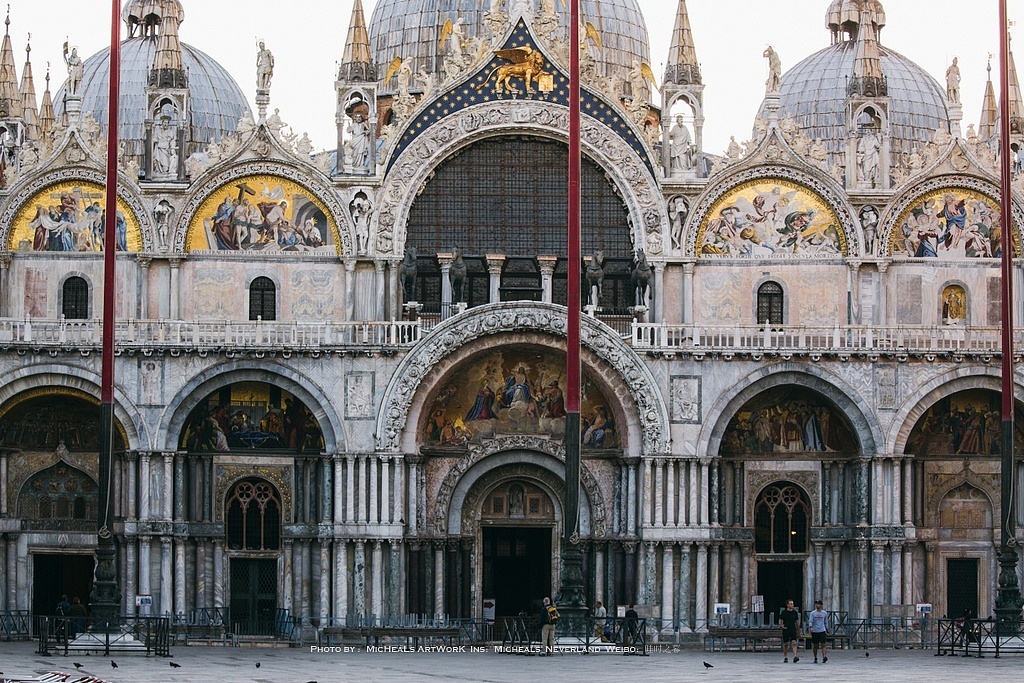 清晨的圣马可圣殿前还没有人头涌动的那种紧凑感，而这时间也仅限于刚刚日出的那几十分钟而已……这座教堂是威尼斯的宗座圣殿，始建于829年，如今的建筑重建于1043-1071年间，称得上中世纪时期欧洲最庞大的教堂建筑，作为历史建筑，它拥有极为丰富的艺术品收藏，唯独可惜的是它内部并不允许拍照……当然了进去参观你会发现它里面的光线颇为昏暗，是那种非常古旧的昏暗感，加上因为建筑不停的需要维护和修复，脚手架其实占据了很大的空间。二层平台可以上去参观，之后在慢慢讲历史什么的吧-0 -~