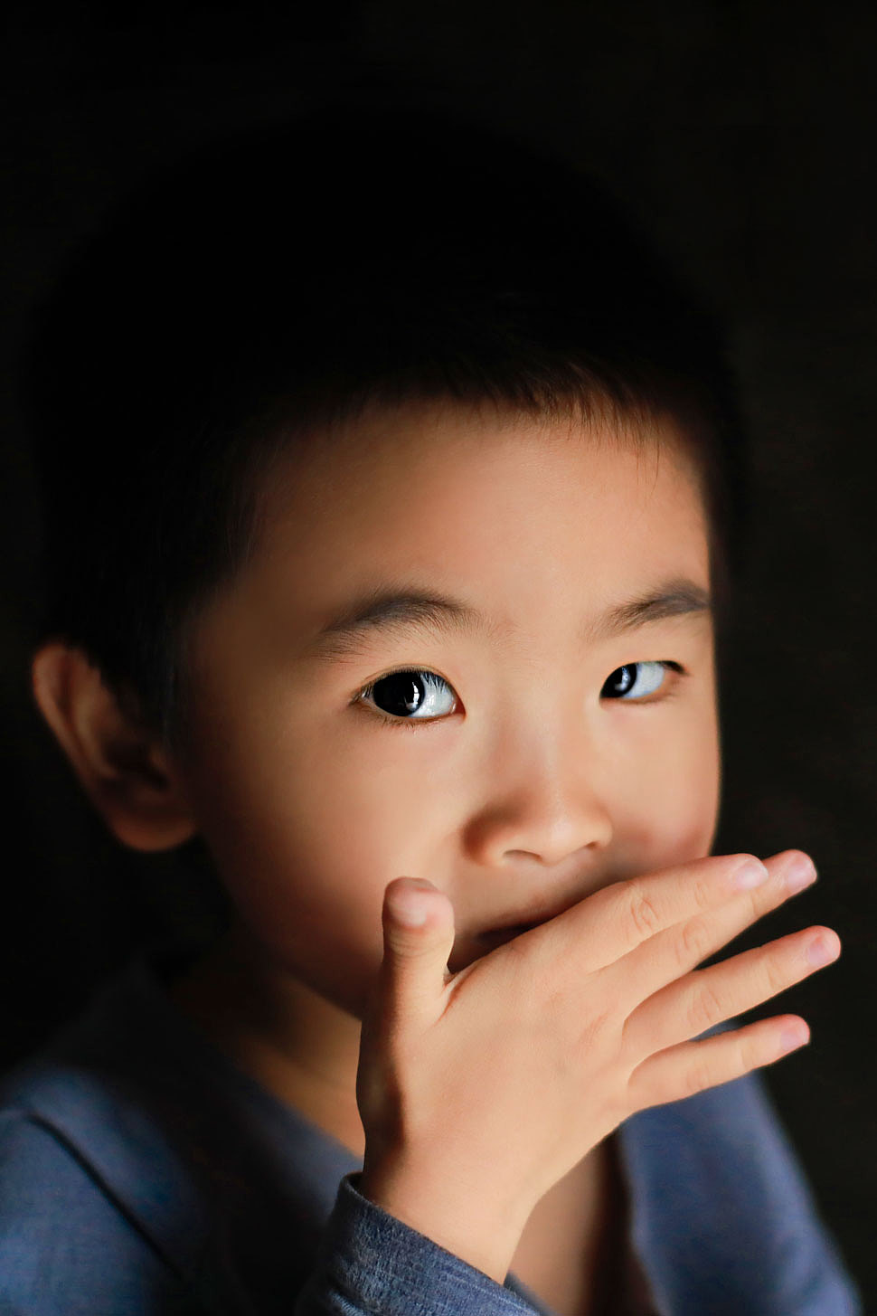 窗前吃零食的小男孩