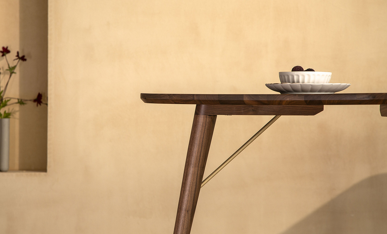 支撑结构锁牢,无立水也可以很稳固
传统的立水设计,目的在于防止桌面变形,增加受力度。<br>Pi餐桌虽然没有立水,但是在水平方向上,桌面内部有钢条嵌入,形变几率更低,在垂直方向上,纤细桌腿比例向外倾斜,且采用了直径为1cm的黄铜棒固定在桌腿上,形成稳固的三角形结构,保证垂直向的支撑力。<br>