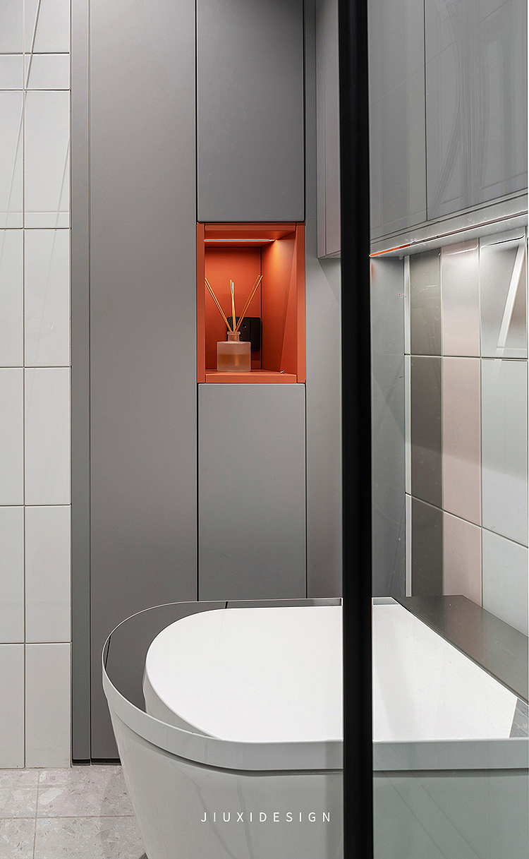 灰色浴室杂物柜用于存放备用的洗浴用品,橙色开放格不仅可以增加对比提升装饰性。还可以摆放香薰和小盆栽,改善空气质量。
